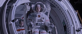 Movie still from “The Martian” (2015), directed by Ridley Scott – A person in a spacesuit sitting on a space ship; Medium shot, Low angle