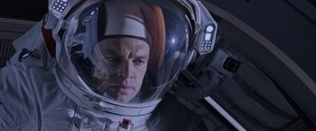 Movie still from “The Martian” (2015), directed by Ridley Scott – A person in a space suit; Close Up shot, Overhead angle