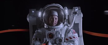 Movie still from “The Martian” (2015), directed by Ridley Scott – A woman in a spacesuit is smiling for the camera; Medium shot, Low angle