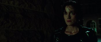 Movie still from “The Matrix” (1999), directed by Lana Wachowski – A person in a dark room; Close Up shot, Low angle