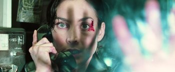 Movie still from “The Matrix” (1999), directed by Lana Wachowski – A person talking on a cell phone; Close Up shot, Overhead angle