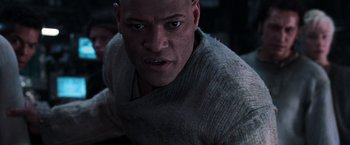 Movie still from “The Matrix” (1999), directed by Lana Wachowski – A person wearing a sweater; Close Up shot, Low angle