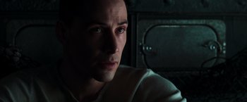 Movie still from “The Matrix” (1999), directed by Lana Wachowski – A person looking at the camera; Close Up shot, High angle