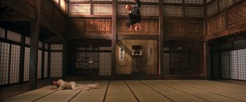 Movie still from “The Matrix” (1999), directed by Lana Wachowski – A man jumping in the air over another man; Wide shot, Low angle