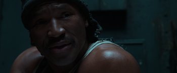 Movie still from “The Matrix” (1999), directed by Lana Wachowski – A man with a mustache; Close Up shot, Low angle