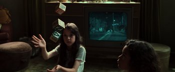 Movie still from “The Matrix” (1999), directed by Lana Wachowski – A young girl sitting in front of a television; Medium shot, Over the shoulder angle