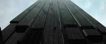 Movie still from “The Matrix” (1999), directed by Lana Wachowski – A person standing on the side of a tall building; Extreme Wide shot, Overhead angle