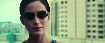Movie still from “The Matrix” (1999), directed by Lana Wachowski – A person wearing sunglasses; Close Up shot, Low angle