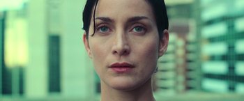 Movie still from “The Matrix” (1999), directed by Lana Wachowski – A woman's face with green eyes; Close Up shot, Low angle