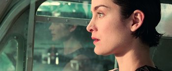 Movie still from “The Matrix” (1999), directed by Lana Wachowski – A person looking out a car window; Close Up shot, Over the shoulder angle