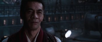 Movie still from “The Matrix Reloaded” (2003), directed by Lana Wachowski – A person wearing a vest; Close Up shot, Over the shoulder angle