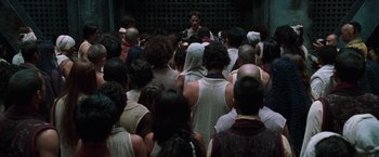 Movie still from “The Matrix Reloaded” (2003), directed by Lana Wachowski – A group of people gathered in a large room; Wide shot, High angle