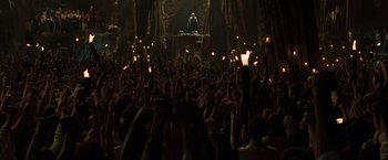 Movie still from “The Matrix Reloaded” (2003), directed by Lana Wachowski – A crowd of people in a dark room with lit candles; Extreme Wide shot, High angle