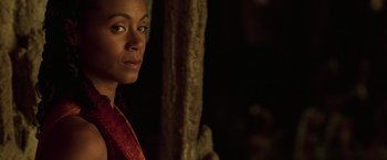 Movie still from “The Matrix Reloaded” (2003), directed by Lana Wachowski – A person wearing a red shirt near a tree; Close Up shot, Over the shoulder angle