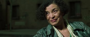Movie still from “The Matrix Reloaded” (2003), directed by Lana Wachowski – An older woman is smiling for the camera; Close Up shot, Low angle