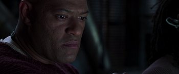 Movie still from “The Matrix Reloaded” (2003), directed by Lana Wachowski – A man's face in the dark; Close Up shot, Low angle