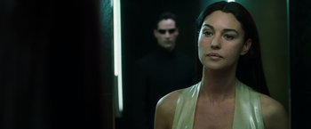 Movie still from “The Matrix Reloaded” (2003), directed by Lana Wachowski – A woman standing next to a man in front of a mirror; Close Up shot, Over the shoulder angle