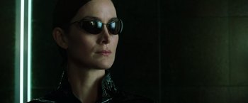 Movie still from “The Matrix Reloaded” (2003), directed by Lana Wachowski – A person wearing sunglasses; Close Up shot, Low angle