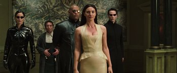 Movie still from “The Matrix Reloaded” (2003), directed by Lana Wachowski – A group of people standing next to each other in a room; Medium shot, Low angle