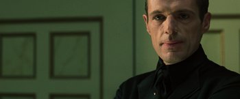 Movie still from “The Matrix Reloaded” (2003), directed by Lana Wachowski – A person wearing a black shirt; Close Up shot, Over the shoulder angle