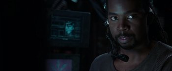 Movie still from “The Matrix Reloaded” (2003), directed by Lana Wachowski – A person wearing a headset; Close Up shot, Over the shoulder angle