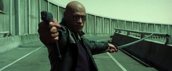 Movie still from “The Matrix Reloaded” (2003), directed by Lana Wachowski – A man holding an axe in his hand; Medium shot, Low angle