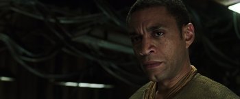 Movie still from “The Matrix Reloaded” (2003), directed by Lana Wachowski – A man's face in a dark room; Close Up shot, Low angle