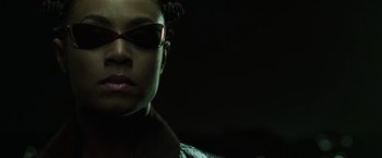 Movie still from “The Matrix Reloaded” (2003), directed by Lana Wachowski – A person wearing sunglasses; Close Up shot, Low angle