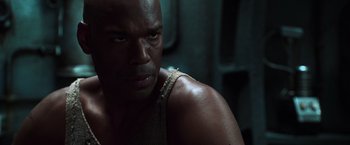 Movie still from “The Matrix Reloaded” (2003), directed by Lana Wachowski – A man's face in the dark; Close Up shot, Low angle