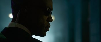 Movie still from “The Matrix Resurrections” (2021), directed by Lana Wachowski – A person wearing sunglasses; Extreme Close Up shot, Low angle