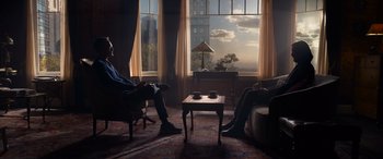 Movie still from “The Matrix Resurrections” (2021), directed by Lana Wachowski – Two people sitting in front of a window in a living room; Wide shot, Over the shoulder angle