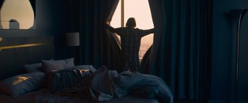 Movie still from “The Matrix Resurrections” (2021), directed by Lana Wachowski – A person standing in front of a window; Wide shot, Low angle