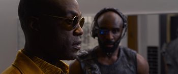 Movie still from “The Matrix Resurrections” (2021), directed by Lana Wachowski – A man wearing a pair of glasses and a man with a beard; Close Up shot, Over the shoulder angle