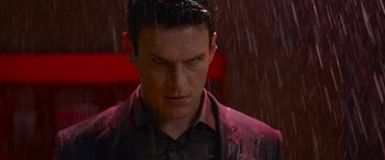 Movie still from “The Matrix Resurrections” (2021), directed by Lana Wachowski – A person standing in the pouring rain; Close Up shot, Low angle