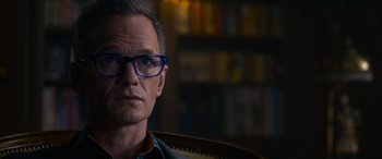 Movie still from “The Matrix Resurrections” (2021), directed by Lana Wachowski – A person wearing glasses; Close Up shot, Over the shoulder angle