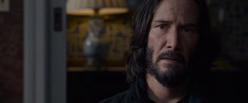 Movie still from “The Matrix Resurrections” (2021), directed by Lana Wachowski – A person with a beard; Close Up shot, Over the shoulder angle