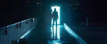 Movie still from “The Matrix Resurrections” (2021), directed by Lana Wachowski – A man standing in the middle of a pool at night; Wide shot, Over the shoulder angle