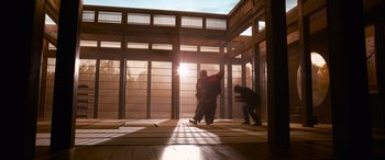 Movie still from “The Matrix Resurrections” (2021), directed by Lana Wachowski – Two people are practicing martial arts in an enclosed area; Extreme Wide shot, Low angle