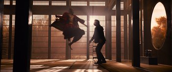 Movie still from “The Matrix Resurrections” (2021), directed by Lana Wachowski – A man is jumping in the air while another man watches; Wide shot, Low angle