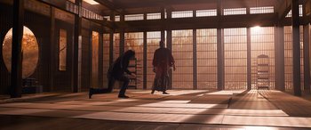 Movie still from “The Matrix Resurrections” (2021), directed by Lana Wachowski – Two men are practicing martial arts in an enclosed area; Extreme Wide shot, Low angle