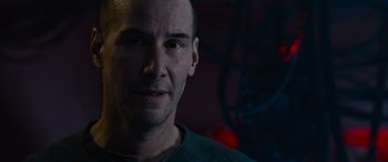 Movie still from “The Matrix Resurrections” (2021), directed by Lana Wachowski – A person wearing a green shirt; Close Up shot, Over the shoulder angle