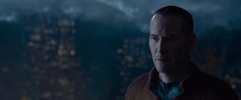 Movie still from “The Matrix Resurrections” (2021), directed by Lana Wachowski – A person wearing a brown jacket; Close Up shot, Over the shoulder angle