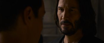 Movie still from “The Matrix Resurrections” (2021), directed by Lana Wachowski – A person talking to another person; Close Up shot, Over the shoulder angle