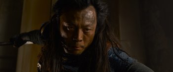 Movie still from “The Matrix Resurrections” (2021), directed by Lana Wachowski – A person with long black hair; Close Up shot, Low angle