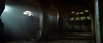 Movie still from “The Matrix Resurrections” (2021), directed by Lana Wachowski – A man standing in the middle of an empty room; Extreme Wide shot, Low angle