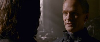 Movie still from “The Matrix Resurrections” (2021), directed by Lana Wachowski – A person wearing a black jacket; Close Up shot, Over the shoulder angle