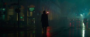 Movie still from “The Matrix Resurrections” (2021), directed by Lana Wachowski – A person walking down a street at night; Extreme Wide shot, Low angle