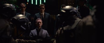 Movie still from “The Matrix Resurrections” (2021), directed by Lana Wachowski – A group of men standing next to each other in a room; Medium shot, Over the shoulder angle