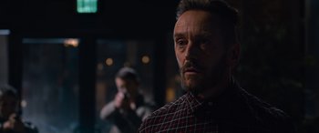 Movie still from “The Matrix Resurrections” (2021), directed by Lana Wachowski – A person wearing a plaid shirt; Close Up shot, Over the shoulder angle