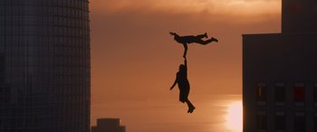 Movie still from “The Matrix Resurrections” (2021), directed by Lana Wachowski – A man and a child are jumping in the air; Extreme Wide shot, Low angle